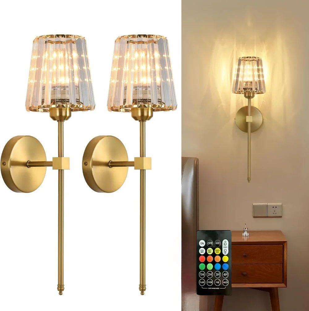 Gold wall sconces with glass shades and a remote control on a white background.