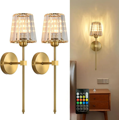 Gold wall sconces with glass shades and a remote control on a white background.